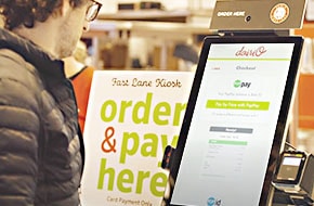 Person ordering and paying on kiosk